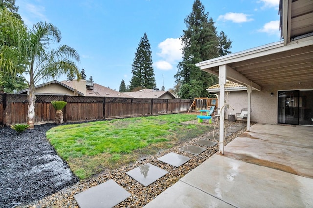 view of yard with a patio, a playground, and a fenced backyard