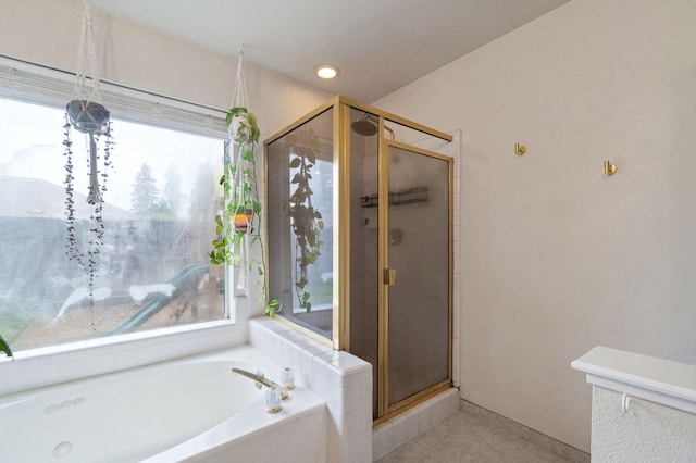 full bath with a stall shower, plenty of natural light, a bath, and tile patterned floors