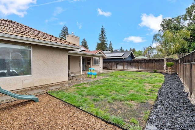 view of yard featuring a patio and a fenced backyard