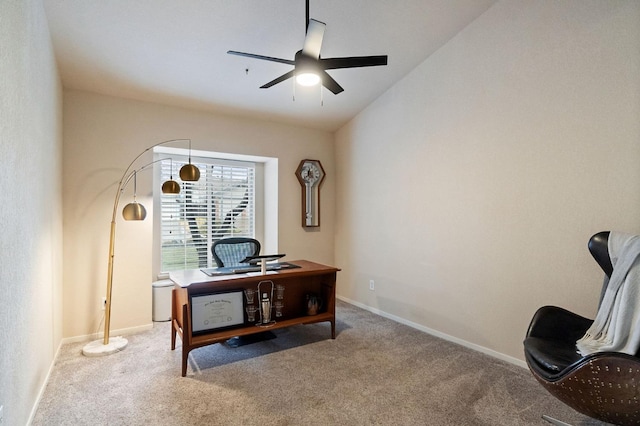 home office featuring carpet floors, ceiling fan, baseboards, and vaulted ceiling