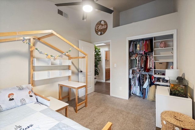 carpeted bedroom featuring a closet and visible vents