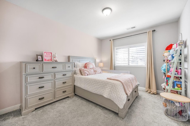 bedroom with baseboards, visible vents, and light colored carpet