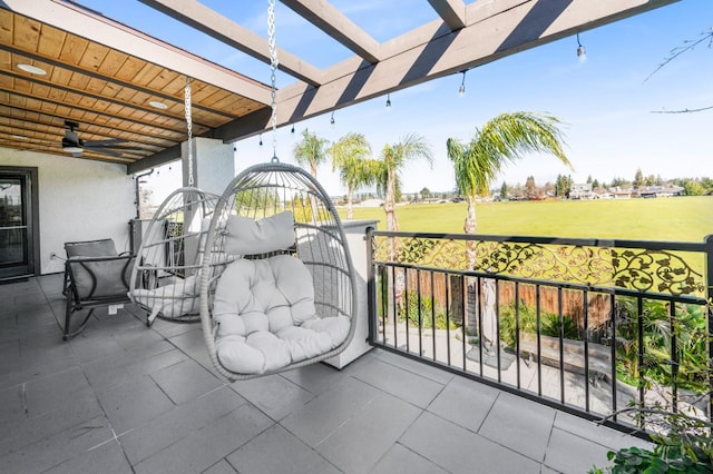 view of patio / terrace with ceiling fan and a pergola