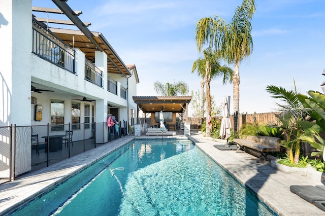 view of pool with a fenced in pool, ceiling fan, a patio, and fence