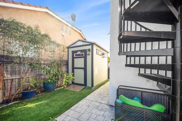 exterior space featuring a shed, an outdoor structure, and fence