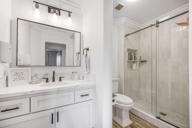 full bath featuring visible vents, toilet, ornamental molding, a stall shower, and vanity