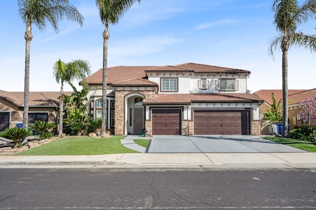 mediterranean / spanish-style house featuring a tile roof, stucco siding, a garage, stone siding, and driveway