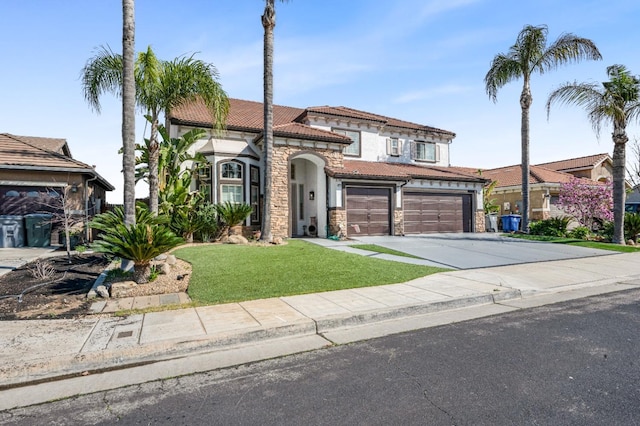 view of front of property with a garage, concrete driveway, stone siding, a tiled roof, and a front yard