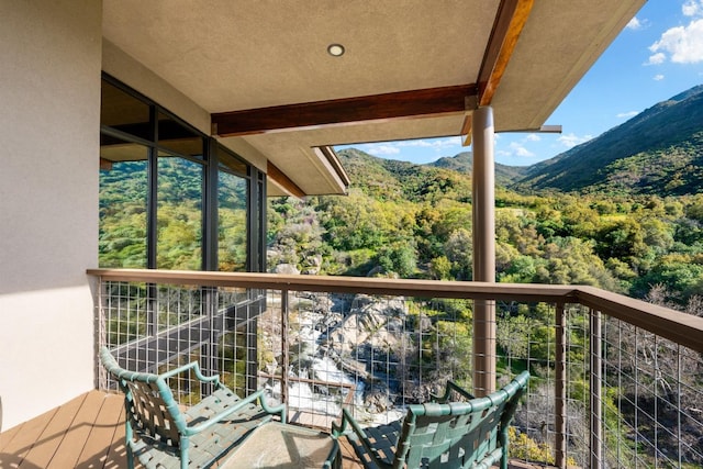 balcony with a mountain view and a forest view