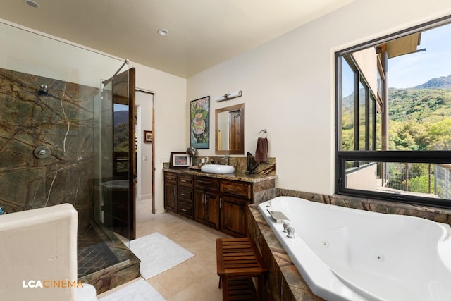 full bath with a whirlpool tub, a shower stall, a wealth of natural light, and vanity