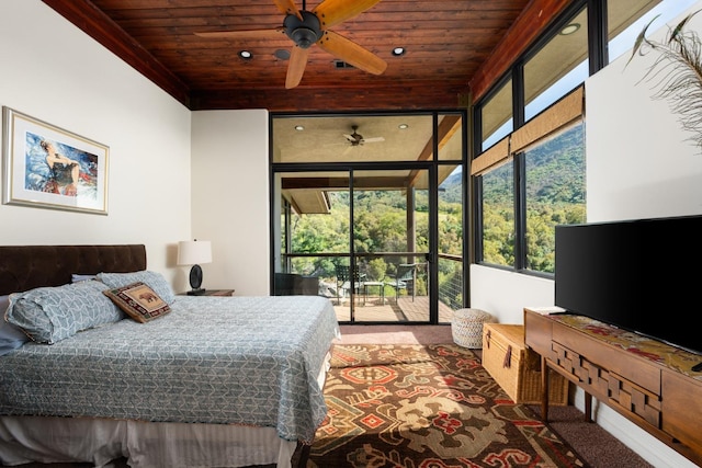 carpeted bedroom featuring expansive windows and wooden ceiling