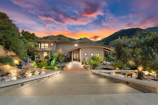 view of front of home with a mountain view and stucco siding