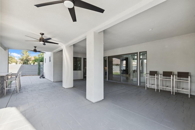 view of patio featuring fence and ceiling fan