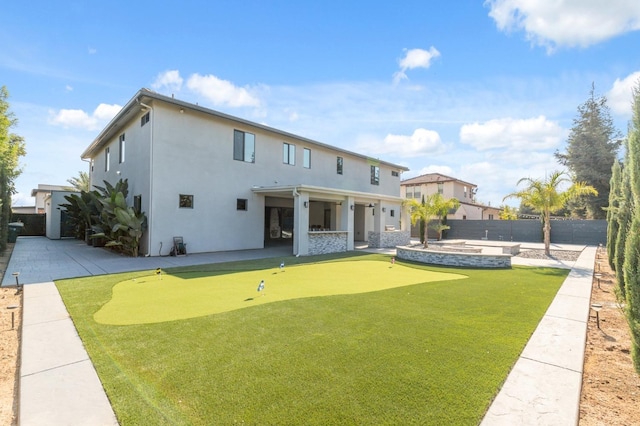 rear view of property with a fenced backyard, a patio, and stucco siding