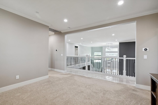 carpeted spare room featuring baseboards, recessed lighting, and crown molding