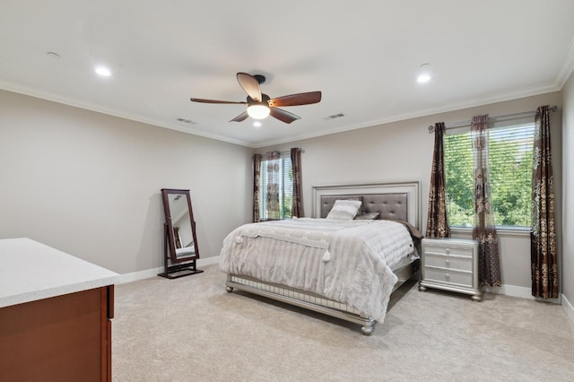 bedroom with ornamental molding, light colored carpet, visible vents, and baseboards