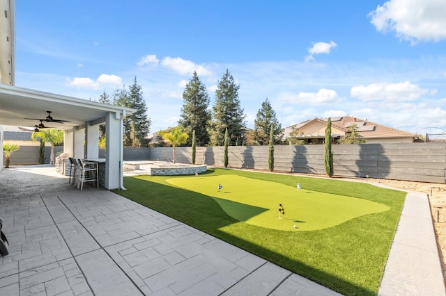 view of yard featuring a fenced backyard, ceiling fan, and a patio