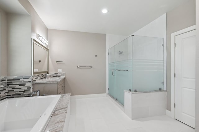 bathroom with recessed lighting, vanity, baseboards, a shower stall, and a bath