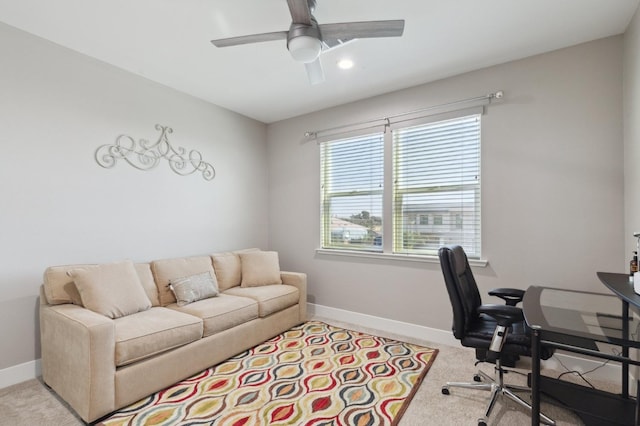 carpeted home office with a ceiling fan and baseboards