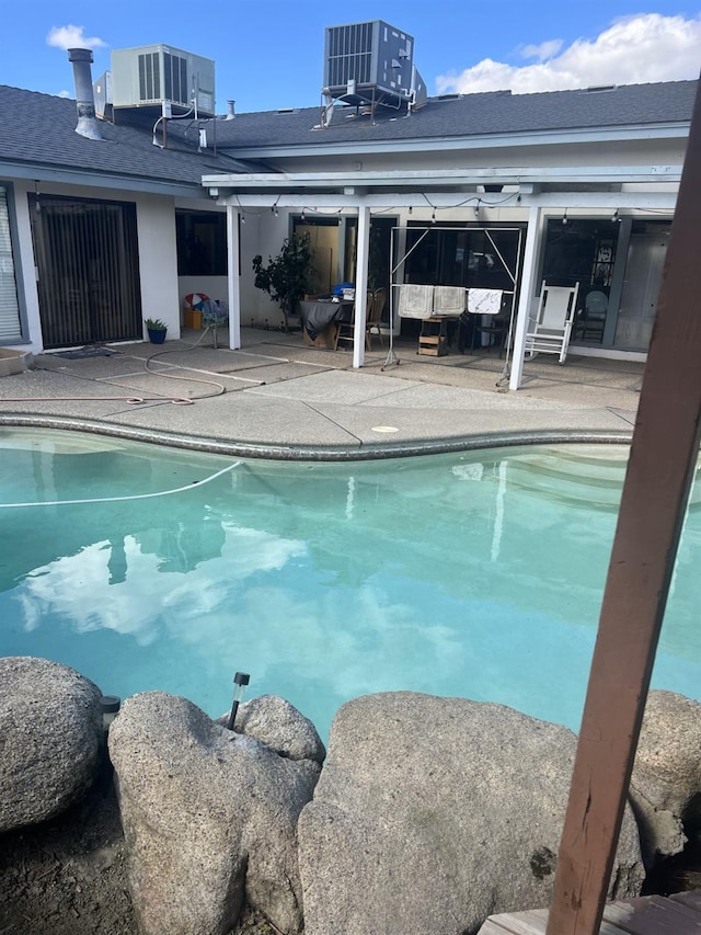 15245 El Mar Ln, Kerman, CA 93630 - outdoor pool featuring central AC and a patio