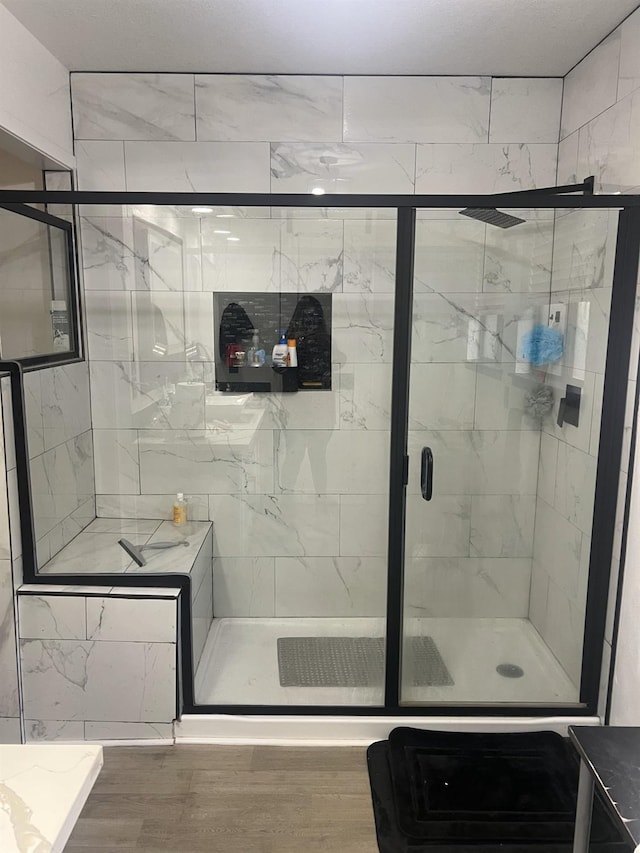 15245 El Mar Ln, Kerman, CA 93630 - bathroom with a stall shower and wood finished floors