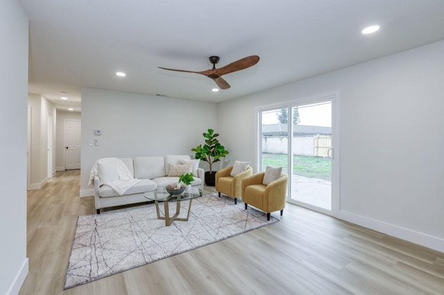 living room featuring recessed lighting, ceiling fan, baseboards, and wood finished floors