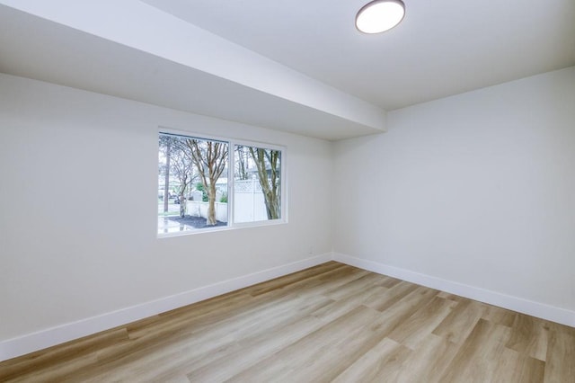 empty room with light wood-style floors and baseboards