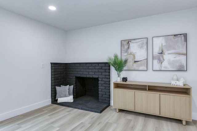 interior details featuring a fireplace, baseboards, wood finished floors, and recessed lighting