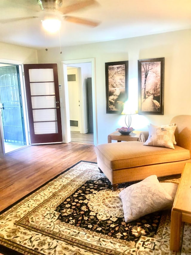 interior space with wood finished floors and a ceiling fan