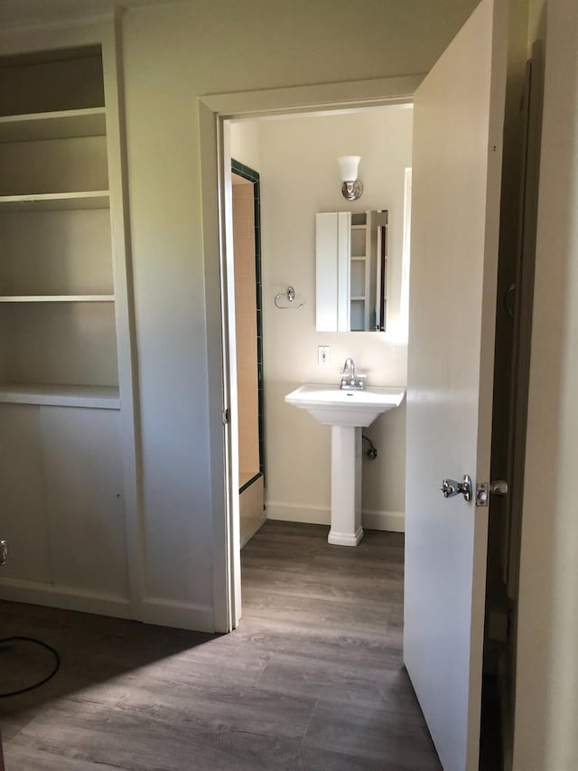 bathroom with wood finished floors and baseboards