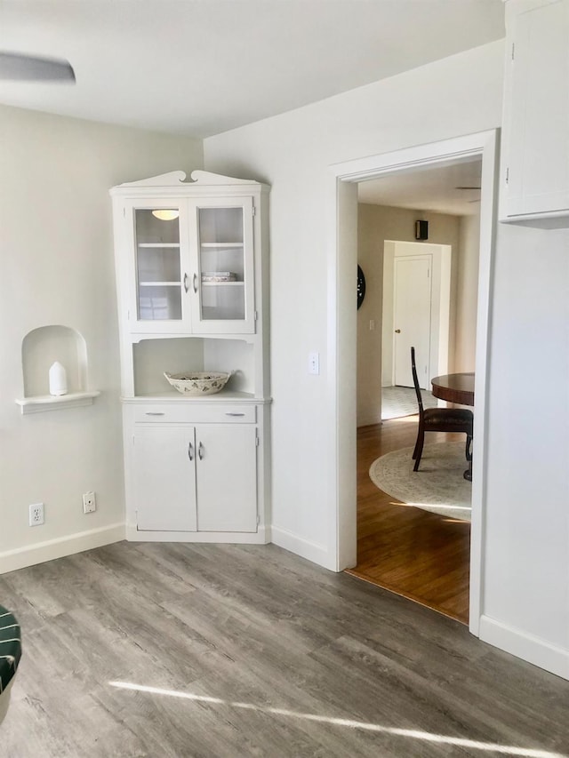 kitchen featuring light wood finished floors, white cabinets, and light countertops