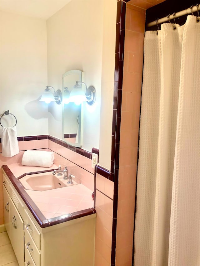 full bathroom with vanity, tile walls, curtained shower, and tile patterned flooring