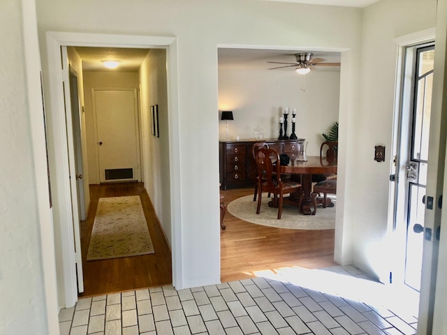 hallway featuring visible vents and light wood-type flooring