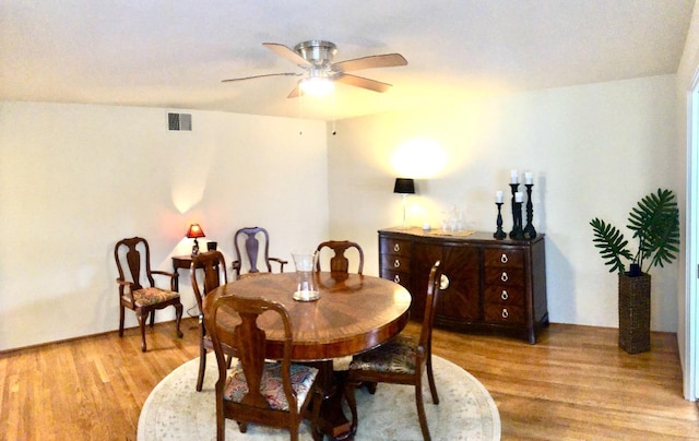 dining room with light wood-style flooring, visible vents, and ceiling fan