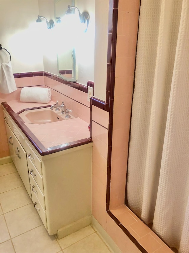 bathroom with tile patterned floors, curtained shower, and vanity