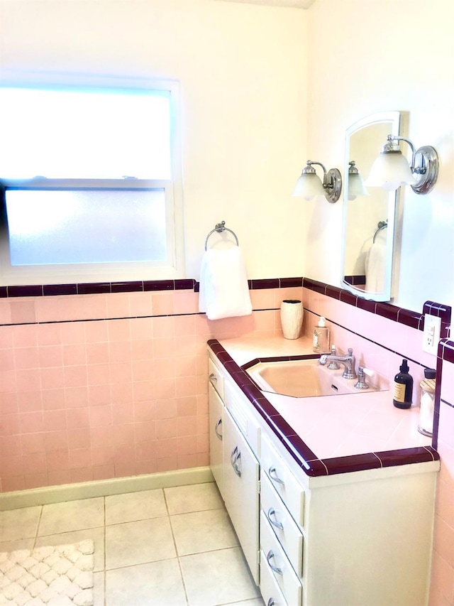 bathroom featuring tile patterned floors, vanity, and tile walls