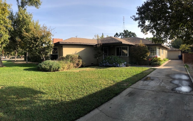 ranch-style home with stucco siding and a front lawn