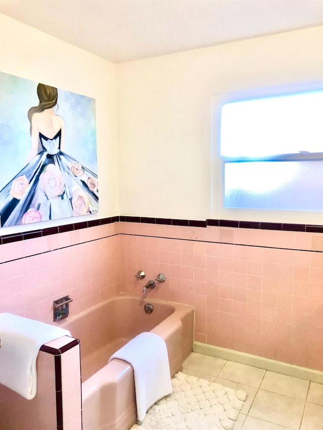 full bathroom featuring tile patterned flooring, tile walls, and a bath