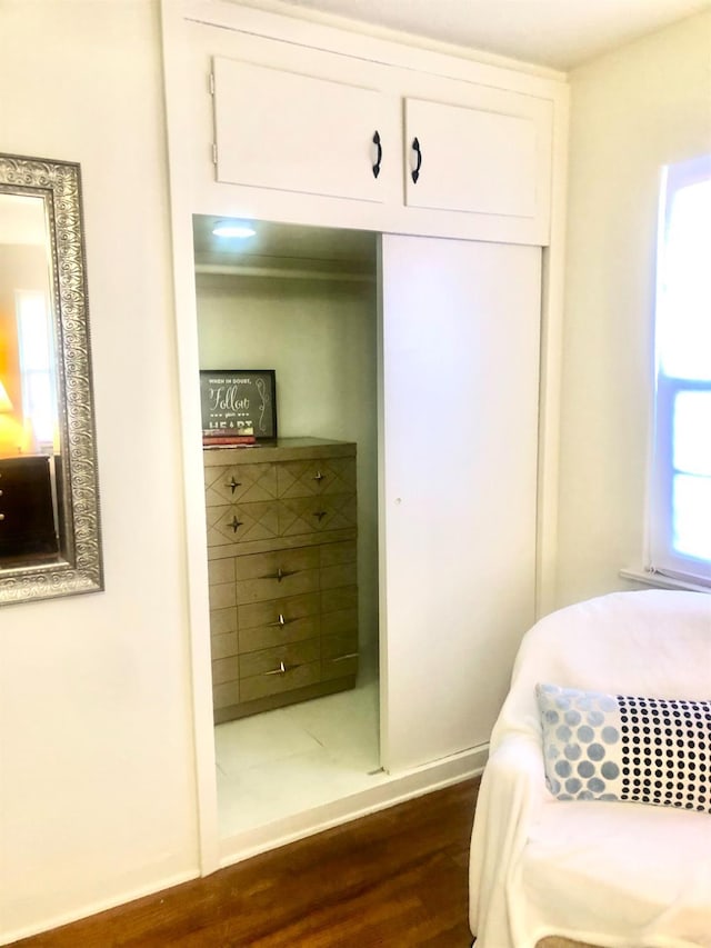 bedroom with a closet and dark wood-style floors