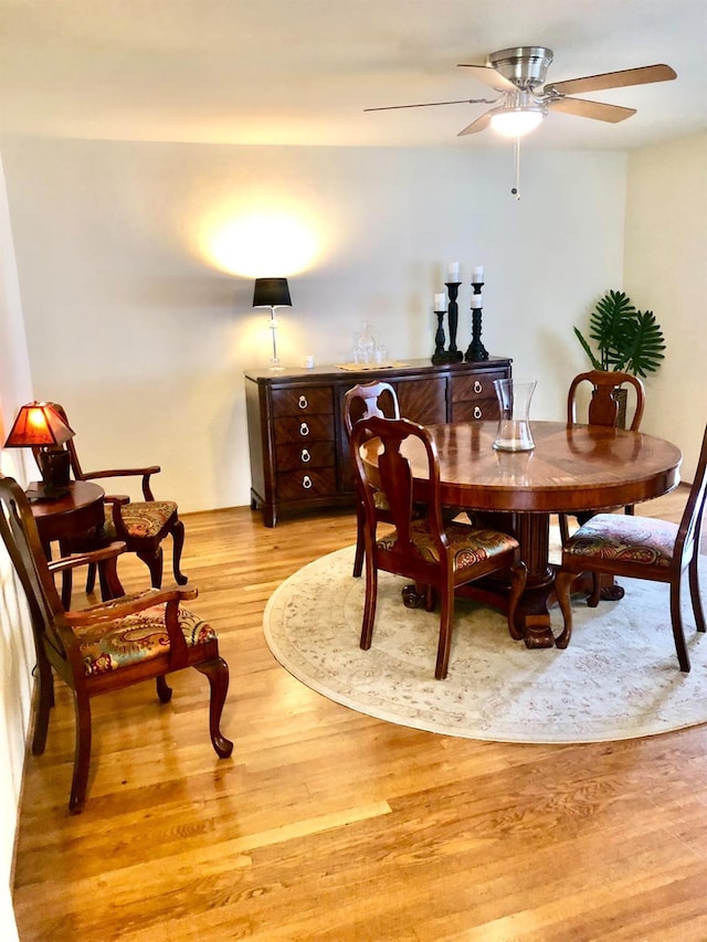 dining room with light wood finished floors and a ceiling fan