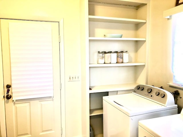 laundry room featuring separate washer and dryer and laundry area