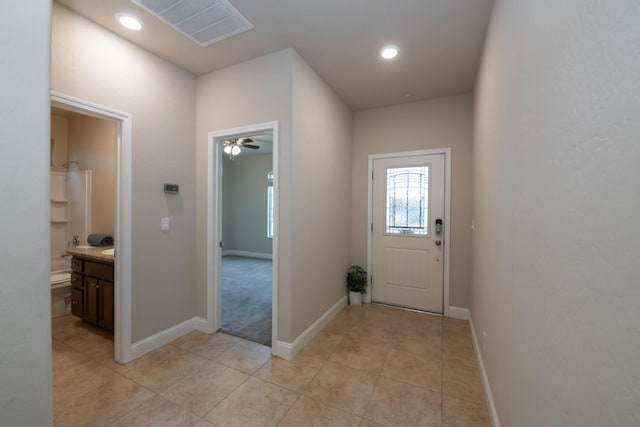 doorway with light tile patterned floors, baseboards, visible vents, and recessed lighting