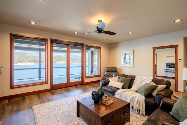 living area featuring baseboards, ceiling fan, wood finished floors, and recessed lighting