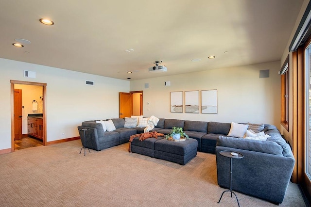 living area featuring recessed lighting, baseboards, visible vents, and carpet flooring