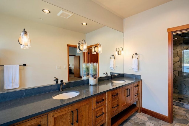 full bath with double vanity, baseboards, a sink, and recessed lighting