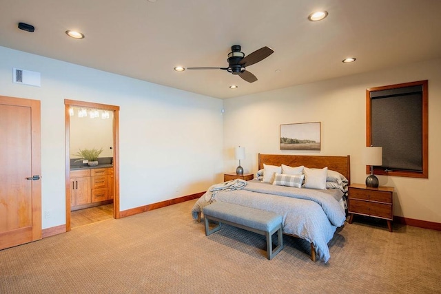 bedroom with recessed lighting, light colored carpet, visible vents, connected bathroom, and baseboards