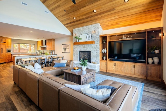 living room featuring wooden ceiling, visible vents, a stone fireplace, and wood finished floors