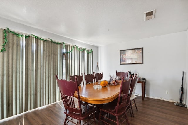 dining area with visible vents and wood finished floors