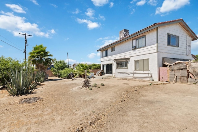 back of house with a patio and fence