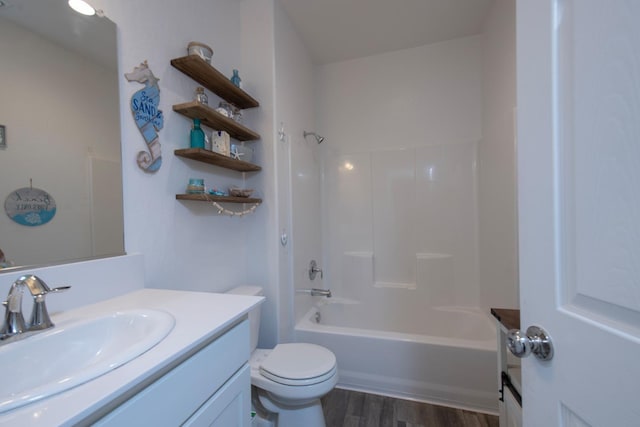 bathroom with toilet, shower / tub combination, wood finished floors, and vanity